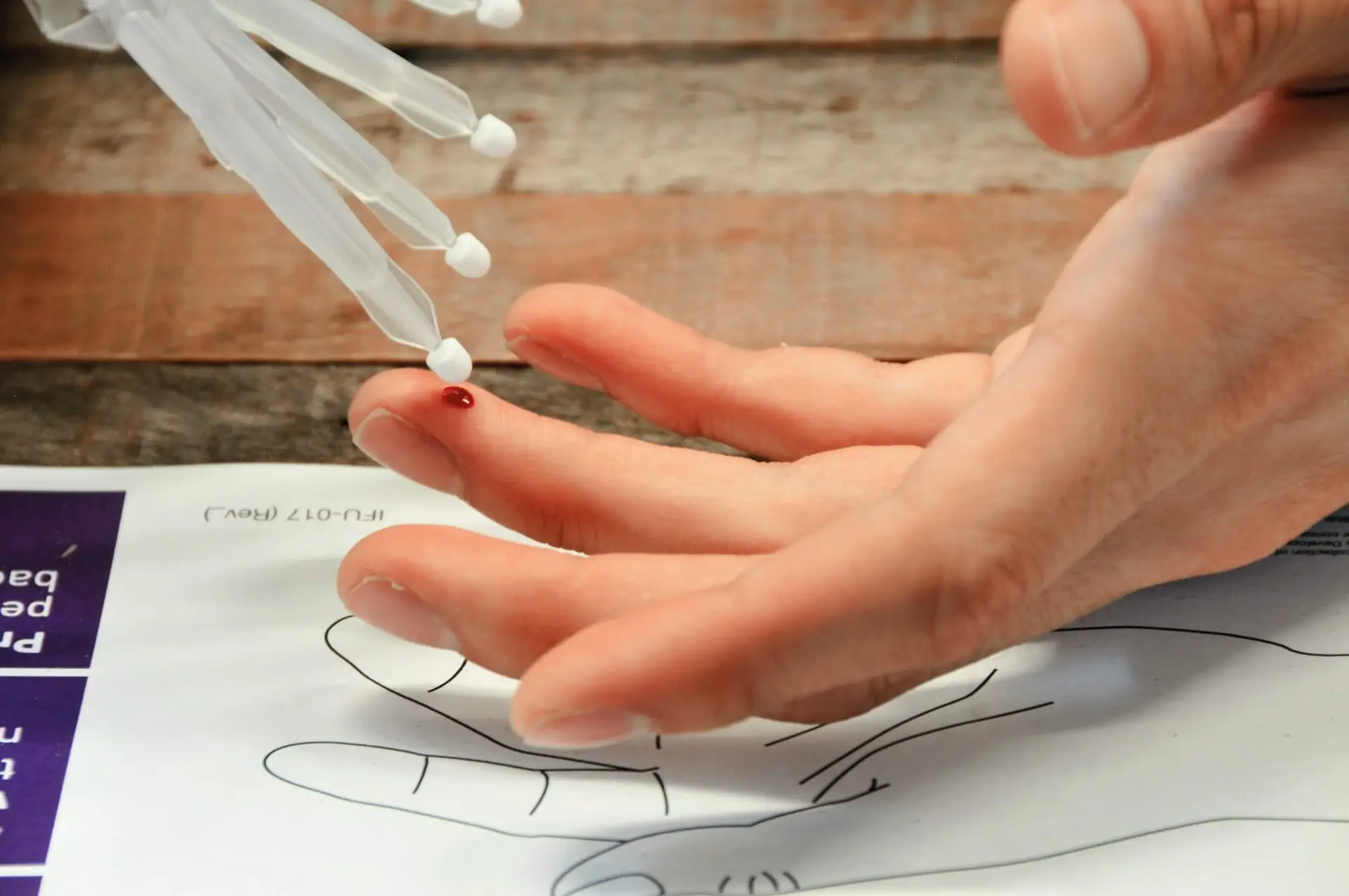 Hand receiving a blood sample test. Microsampling. Resolian Bioanalytics and Analytical Sciences.